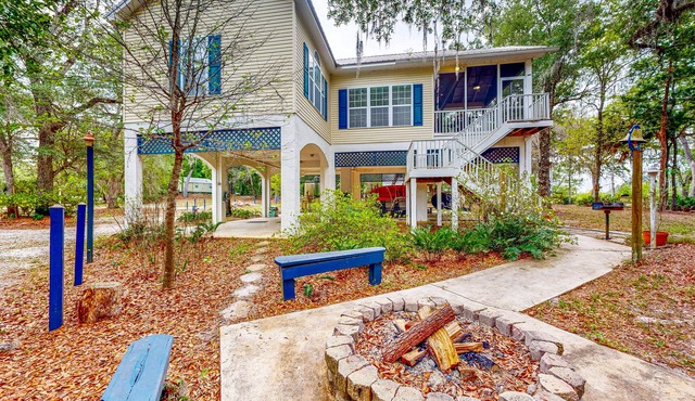 Dog-friendly riverfront home with screened porch, firepit, & private dock