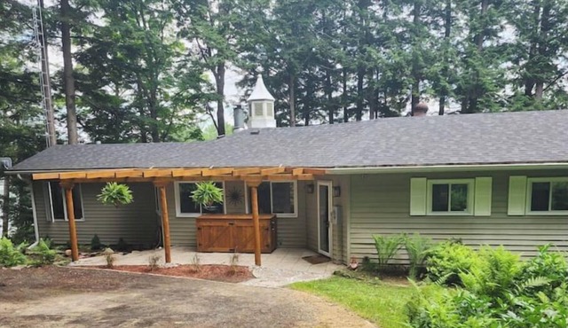 Spacious, waterfront home surrounded by trees with large dock & games room.