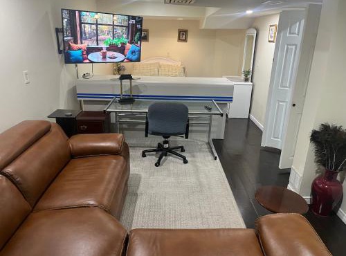 bachelor basement apartment with private kitchenette, washroom, and parking